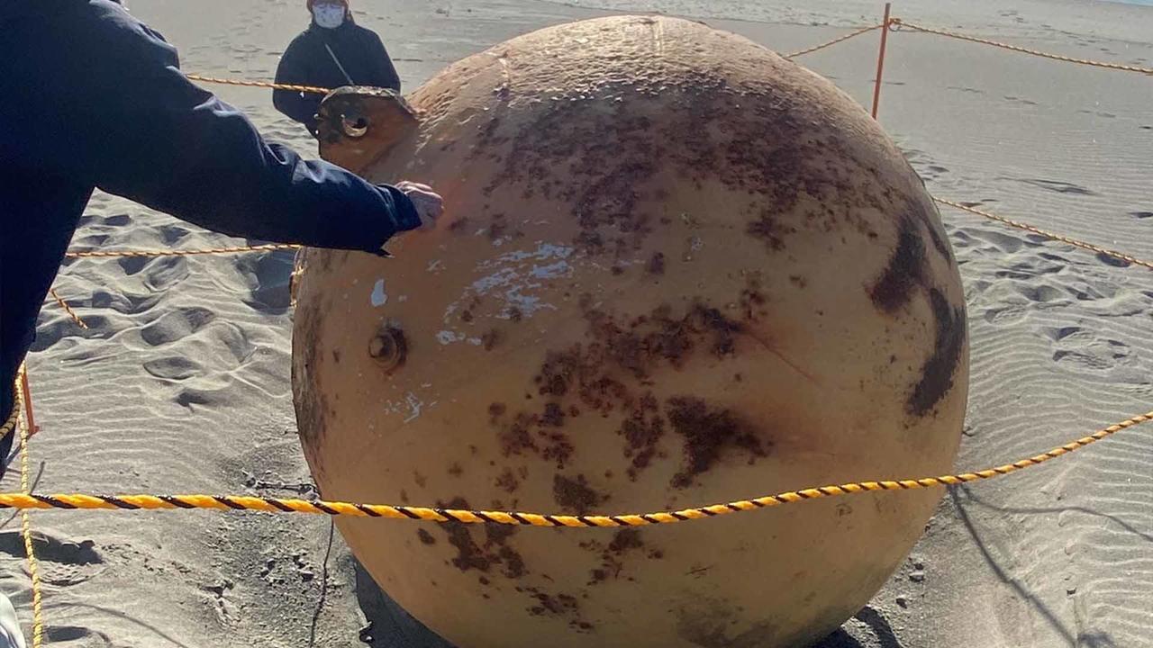 Spy weapon or remnant from outer space? Giant metal ball washes ashore Japan beach